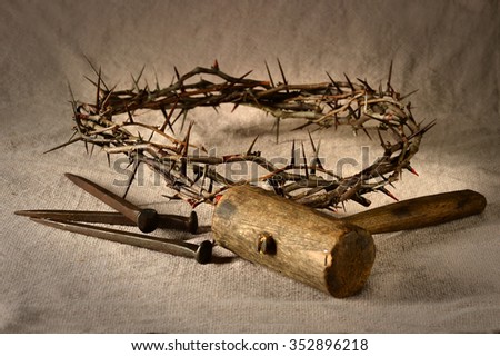 Crown of thorns and nails with mallet over cloth