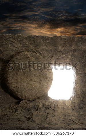 Open tomb of jesus with light coming out of opening