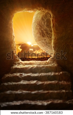 Open tomb of Jesus with sun appearing through entrance - Shallow depth of field on stone