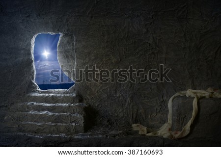 Empty tomb of Jesus at night with crosses in background