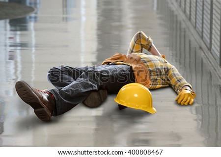 Injured construction worker laying on floor after fall