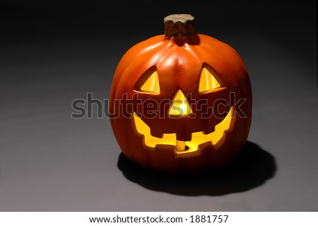 Jack-o-lantern with candle over dark gradient background