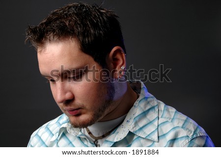 Portrait of young man thinking and looking down