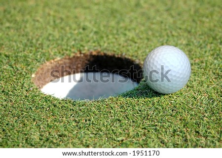 Close-up of Golf Ball Going in the Hole