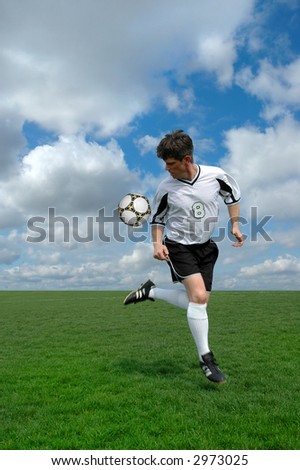 Soccer player performing a back kick over a colorful background.