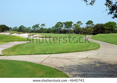 View of golf course with fairway and sand traps