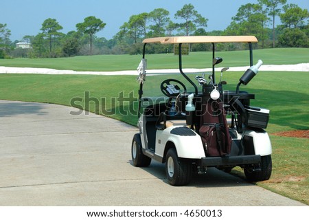 Golf cart on path of golf course