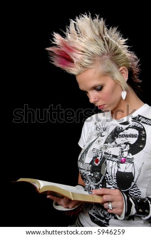 stock photo Punk girl reading the Bible isolated over a black background