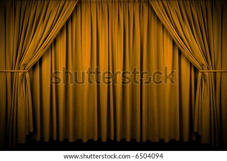 Large golden curtain with spot light and fading into dark.