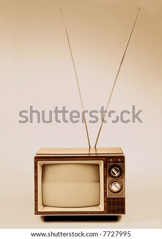 Vintage TV with antenna over a sepia background.
