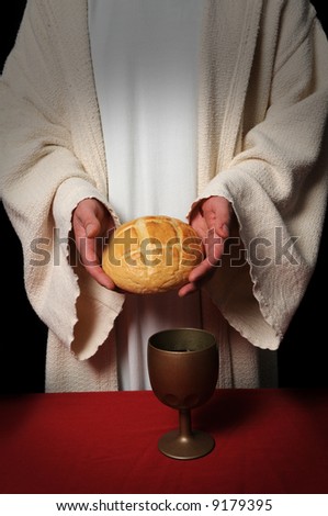 Jesus hands holding the bread at the Communion table