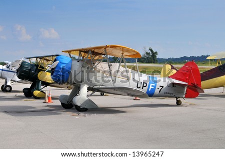 Vintage aircraft on the ground including PT-17 and Waco biplanes