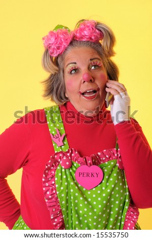 Clown using cell phone to call over a yellow background