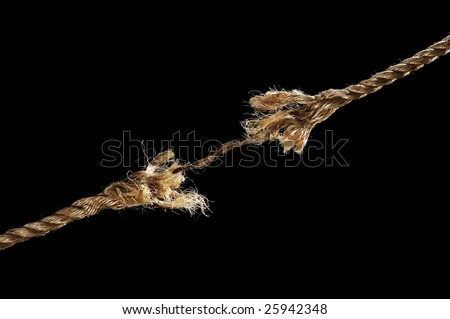 Frayed rope about to break isolated over black background