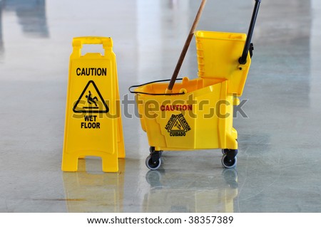 stock-photo-mop-bucket-and-caution-sign-on-wet-floor-38357389.jpg