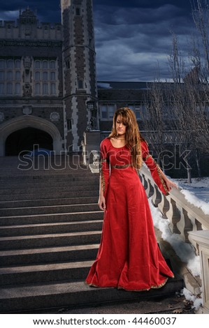 Beautiful young woman on steps dressed in Renaissance clothing