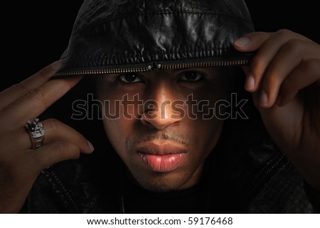 Portrait of African American with hood over head with strong directional light
