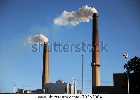 Industrial smokestacks releasing smoke into the environment