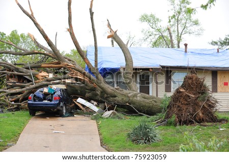 SAINT LOUIS, MISSOURI - APRIL 23: Damaged home with tarp-covered roof after tornadoes hit the Maryland Heights area on Friday April 22, 2011 in Saint Louis, Missouri.