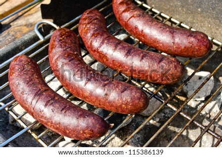 Black pudding during the preparation on the grill