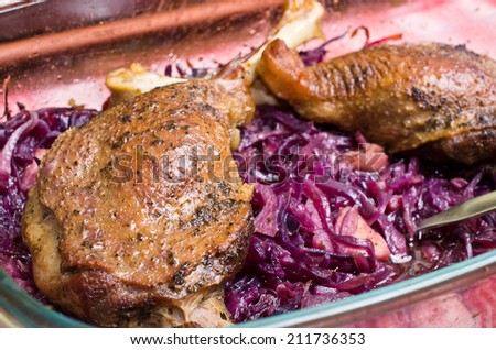 Delicious goose legs baked on red cabbage