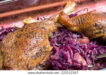 Delicious goose legs baked on red cabbage