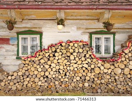 Stack of wood near old cottage windows