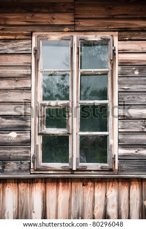 Old window in wooden cottage