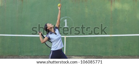 Female tennis player getting ready to serve