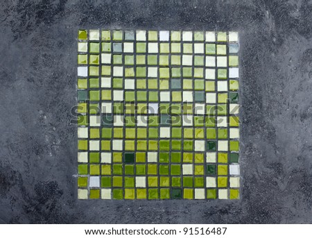 Green ceramics mosaic in concrete table