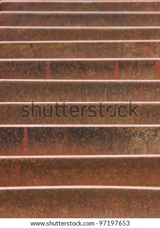 Abstract view of a rusted metal storm drain on street