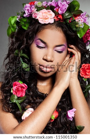 Elegant mulatto girl with circlet of flowers