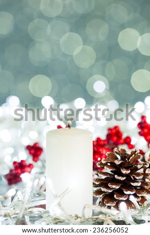 Candle with flame on sparkles background