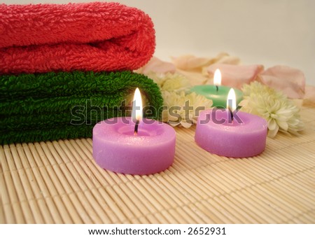 Spa essentials (candles and towels with flowers)