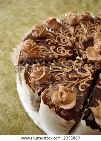 part of chocolate cake with flowers on textured background