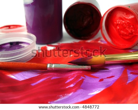 Brushes and red paint jar with gouache