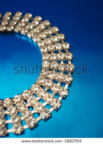 Close up of diamond necklace on blue background