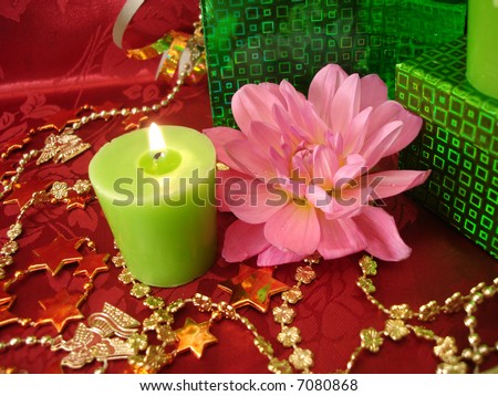 celebration table (candles, flowers and gift on red background)
