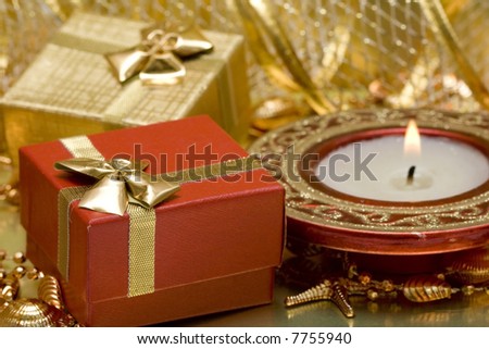 gift boxes and burning candle