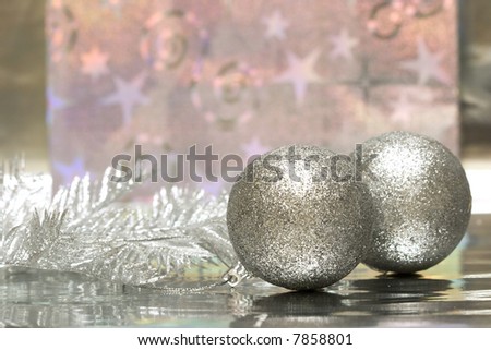 Christmas balls with package on silver background