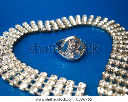 diamond necklace with ring on blue background