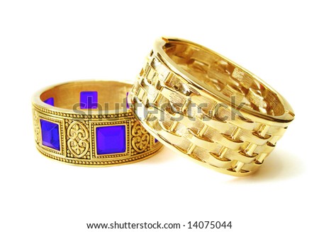 Close-up of golden bracelets isolated on white background