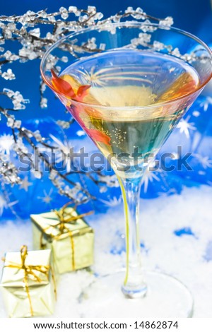 glass with champagne and gift boxes