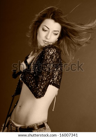 beautiful girl with flying hairs on wind in sepia