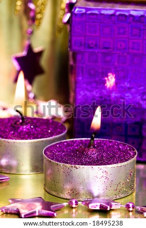 violet gift box and burning candle
