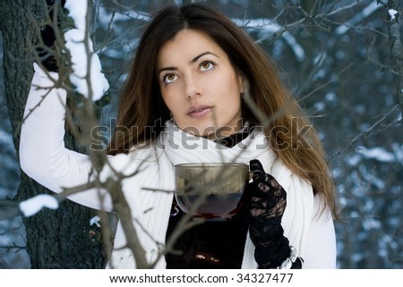 Beautiful woman in the forest with a cup of tea