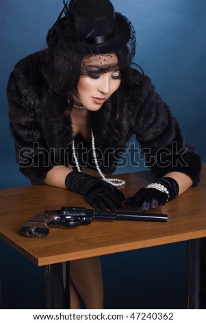 elegant lady with a pistol in hands