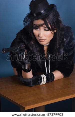 elegant lady with a pistol in hands
