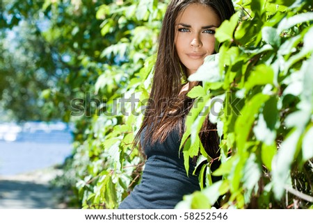 Beautiful woman near the bush
