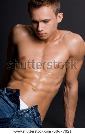 young bodybuilder man on black background